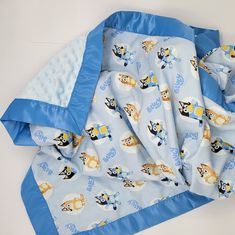 a blue blanket with cartoon characters on it