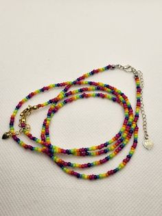 Thanks for visiting my shop. Rainbow necklace, made with seed beads and a 14k gold plated or 924 silver plated clasp and extension chain. 15" length + 2" extension Colors may vary slightly depending on material availability. I do my best to ensure the durability of my jewelry, however please be sure to treat your jewelry with care. Care: remove before showering or swimming. Do not spray perfume or other spray on it. Adjustable Rainbow Beaded Necklace, Adjustable Rainbow Beaded Necklace With Beaded Chain, Rainbow Necklaces With Tiny Round Beads, Rainbow Necklace With Tiny Round Beads, Adjustable Rainbow Necklaces With Polished Beads, Adjustable Rainbow Polished Beads Necklace, Rainbow Round Beaded Necklaces With Tiny Beads, Adjustable Rainbow Single Strand Beads, Adjustable Single Strand Rainbow Beads