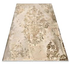 an area rug with white and beige designs on the ground, in front of a white background