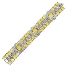 Oscar Heyman Yellow Sapphire And Diamond Bracelet In platinum and 18k gold. Circa 1950. This beautiful bracelet showcases an array of yellow sapphires and diamonds. There is total of three emerald cut yellow sapphires, with total weight of 27.00ct, and 30 cut corner square sapphires, with total weight of 101.08ct. Accented with 168 round brilliant cut diamonds with weight of 9.28ct, and 18 baguette cut diamonds with total weight of 2.25ct There is total of 128.08ct of yellow sapphires and total Luxury Yellow Fine Jewelry Bracelets, Sea House, Yellow Jewelry, Expensive Jewelry, Bracelet Gemstone, Baguette Cut Diamond, Sapphire Bracelet, Baguette Cut, Yellow Sapphire