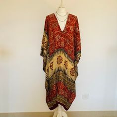 A Beautiful Silk Boho Kaftan,Dress ,Cover Up. Long and Sequinned,Embroidered,Silk and Floaty,Perfect for Poolside,Beach Holidays,Festivals or Parties.  Handmade in India from a Vintage Silk Sari,so completely Unique and Sustainable. This dress flows loosely from the shoulders,with a V neckline and a softly draped silhouette, The fabric is a Beautiful Printed Silk in Sand and Orange,with Gorgeous Glittering Gold Sequins. It feels loose and floaty to wear,and easy ro roll up to take away. One Size Hippie Maxi Dress, Silk Party Dress, Summer Cover Up, Etsy Boutique, Beach Holidays, Maxi Dress Long, Silk Sari, Embroidered Tunic, Gold Sequins