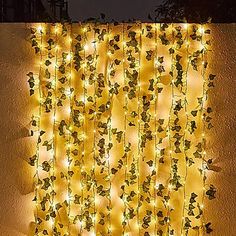 a wall covered in vines and lights