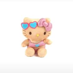 a small hello kitty stuffed animal with heart shaped sunglasses on it's head and pink outfit