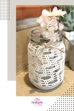 a glass jar with some flowers in it