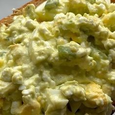 an open faced sandwich with eggs and vegetables on it