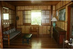 a living room with wood paneling and wooden furniture