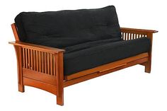 a wooden futon with black cushions on it