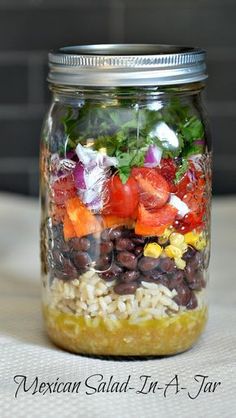 a mason jar filled with mexican salad in a jar