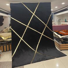 a large black piece of art sitting on top of a tiled floor in a room