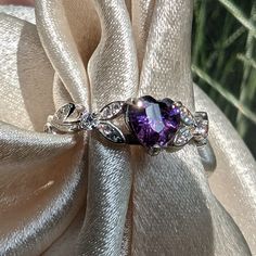 Brilliant sparkle with a lush Amethyst Cubic Zirconia heart shaped stone, this White Gold Amethyst engagement ring has a core of solid 925 Sterling Silver, making it hypoallergenic and built to last! The high-quality faceted heart stone is 6mm (0.8 carat) and has a Mohs hardness of 8-1/2. Sprinkled generously with cubic zirconia rhinestones, this lovely Amethyst ring is accented by a nature-inspired tree branch and leaf design.It would make a great promise ring or engagement ring, as well as an Engagement Ring Heart, Heart Shaped Engagement Rings, Heart Shaped Ring, Amethyst Engagement Ring, Amethyst Ring Engagement, Ring Heart, Heart Stone, Heart Engagement Rings, Heart Shaped Rings