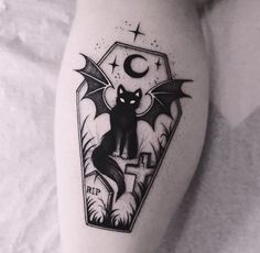 a black cat tattoo on the leg