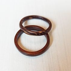 two wooden rings sitting on top of a white table