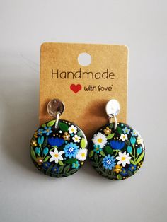 a pair of earrings with flowers on them