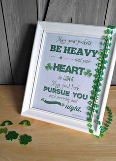 a frame that has some shamrocks on it and the words, be heavy heart to light