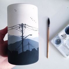 someone is holding up a coffee mug that has an image of power lines on it