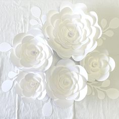 paper flowers are arranged on a white table cloth