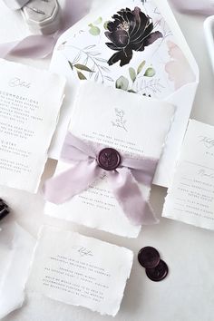 the wedding stationery is laid out on the table