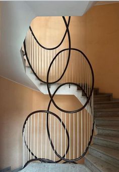 a spiral staircase with metal railings in an apartment