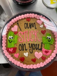 there is a cake decorated with the words i am stuck on you and two pickles