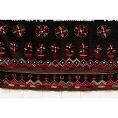 This fabulous antique Kohistani shawl whispers stories of the Mangal people, inhabiting the borderlands of eastern Afghanistan and western Pakistan. This antique shawl was Traditionally worn by women as a head covering during wedding or ceremonies, this piece is a testament to the Mangal's artistry and cultural heritage. Hand-crafted from heavy black cotton, the shawl is adorned with intricate silk embroidery. Geometric and floral motifs in vibrant colors like red, green and yellow dance across Ceremonial Shawl With Motifs, Bohemian Shawl With Embroidered Border For Festival, Folk Shawl With Embroidered Border, Ceremonial Shawl With Motifs For Festivals, Traditional Pashmina Shawl For Ceremonial Festivals, Traditional Ceremonial Dupatta Shawl, Intricately Embroidered Shawl For Traditional Ceremonies And Festivals, Traditional Shawl-style Dupatta With Border, Traditional Dupatta Shawl With Border