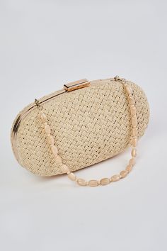 In a Natural tone, this versatile clutch is an ideal summer accessory. With a hard casing featuring a hand woven outer, we adore the detachable beaded shell strap and easy metal snap closure. Crafted to complement our Corsica collection, this charming oval-shaped bag is a must-have clutch of the season. Elegant Clutch As Fashion Accessory For Spring, Elegant Spring Fashion Accessory Clutch, Woven Straw Bag As Fashion Accessory, Elegant Beige Clutch For Summer, Chic Summer Clutch For Fashion, Elegant Woven Clutch For Vacation, Beaded Beige Straw Bag, Elegant Summer Straw Bag With Pearl Handle, Elegant Beige Braided Straw Bag