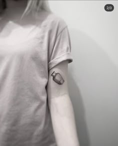 a woman with a small tattoo on her arm