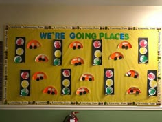 a bulletin board that says we're going places with cars and traffic lights on it