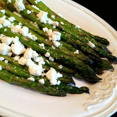 asparagus with cottage cheese on a white plate