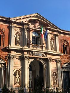 an old building with statues on the front