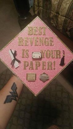 a pink graduation cap with the words best revenge is your paper on it