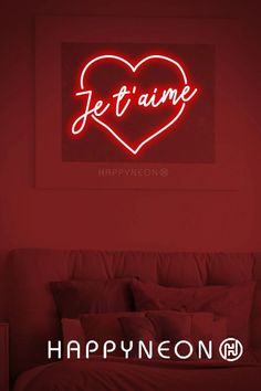 a neon sign that says je t'aime on it in the shape of a heart