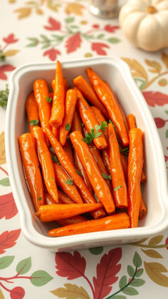 a white bowl filled with carrots on top of a table