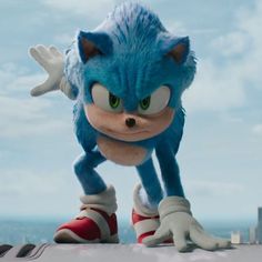 sonic the hedgehog is standing on top of a building with his feet in the air