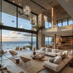 the living room is very large and has glass walls to look out onto the ocean