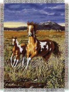 two horses are standing in the grass