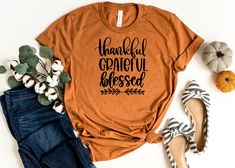 "Thankful Blessed T-Shirt | Thanksgiving T Shirt | Fall Shirt | Fall Shirt Women | Fall Tee Shirt | Fall Teacher Shirt | Pumpkin Spice Outfit How To Order: 1 - Please, check and review all photos 2 - Choose your t-shirt size and color *Different styles of shirts may have different shades of same color choice due to different manufacturer brands. *For this reason, we recommend you to match shirts from the same styles if you want precisely matching colors (exa. Unisex, V-neck, Tank top, etc.). 3 - Spice Outfit, Fall Tee, Brand Book, Fashion Portfolio, Create Shirts, Fall Shirt, Soft Textiles, Handmade Business, Fall Shirts