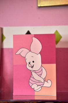 a card with an image of a rabbit on it's chest, sitting on a shelf