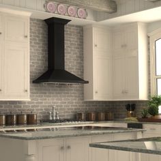 a kitchen with white cabinets and black stove top hood over the island in front of an oven