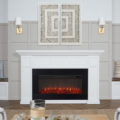 a living room with a fire place in the center and white furniture on the other side