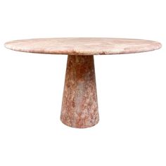 a round marble table with an iron base on a white background for use as a centerpiece