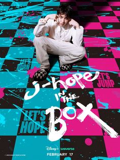 a man sitting on top of a checkered floor next to a pink and blue poster