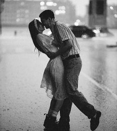 a man and woman kissing in the rain