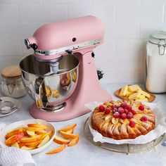 a pink mixer and some food on a table