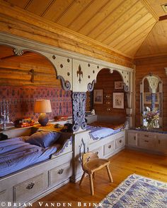 a bedroom with two beds and a dresser in it