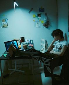 a person sitting at a desk in front of a computer