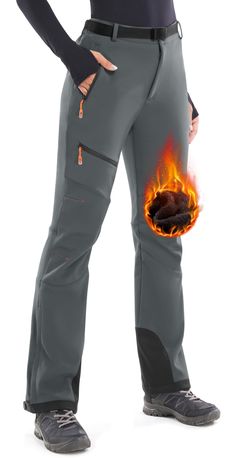 a woman in grey pants with flames on the side