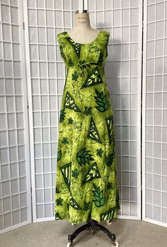 This gorgeous Hawaiian maxi dress is made of a cotton bark cloth in a rare shade of chartreuse with shades of green and black. There is a scoop-neck collar and a nylon zipper in the back. It is in clean, ready-to-wear, excellent condition! Bust - 36-38 Waist - 30 Hips - 40 Shoulder to hem - 52 Every effort is made to accurately describe the condition of our items and their measurements. We want you to be happy with your purchase. All items are pre-worn, vintage and may show some signs of aging. Green Fitted Casual Maxi Dress, Casual Fitted Green Maxi Dress, Green Cotton Maxi Dress For Beach, Green Floor-length Cotton Dress, Hawaiian Halter Dress, Hawaiian Maxi Dress, Bark Cloth, Fringe Jacket, Wiggle Dress