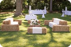 hay bales are arranged on the lawn for a wedding reception