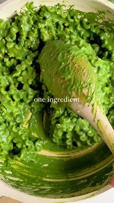 a person is mixing green food in a bowl with a wooden spoon and the words one ingredient above it