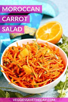 a white bowl filled with carrot salad next to an orange slice